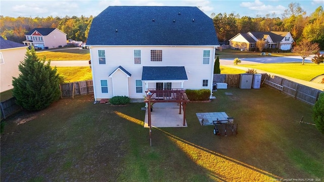 back of house featuring a patio and roof with shingles