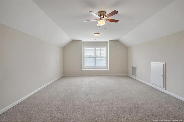 additional living space featuring lofted ceiling, a ceiling fan, baseboards, and carpet floors