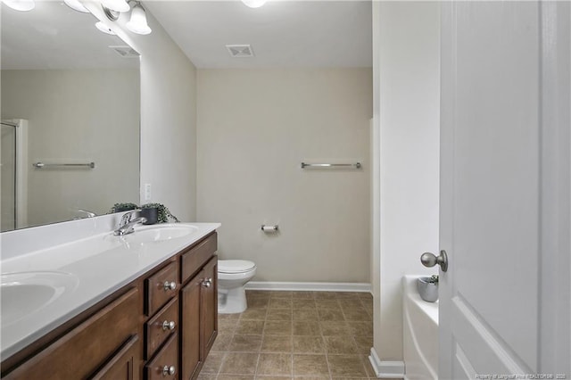 full bathroom with double vanity, toilet, and baseboards
