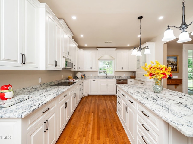 8917 Thompson Mill Rd, Wake Forest, NC 27587 - kitchen featuring stainless steel microwave, light wood-type flooring, white cabinets, black electric cooktop, and recessed lighting