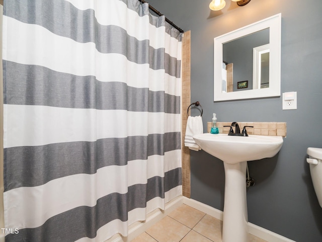 8917 Thompson Mill Rd, Wake Forest, NC 27587 - full bathroom featuring tile patterned floors, toilet, curtained shower, and baseboards