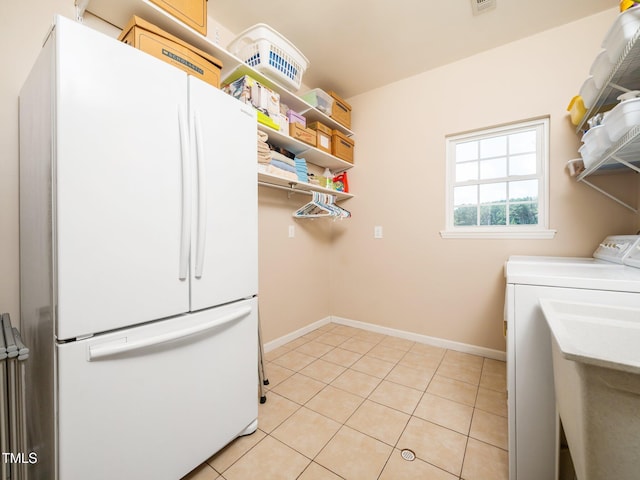 8917 Thompson Mill Rd, Wake Forest, NC 27587 - laundry room with light tile patterned flooring, separate washer and dryer, and baseboards