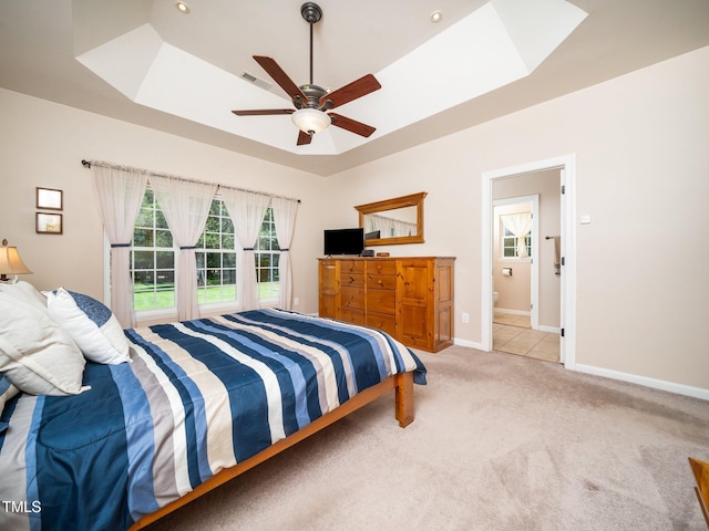 8917 Thompson Mill Rd, Wake Forest, NC 27587 - bedroom with light carpet, baseboards, a skylight, a tray ceiling, and a ceiling fan