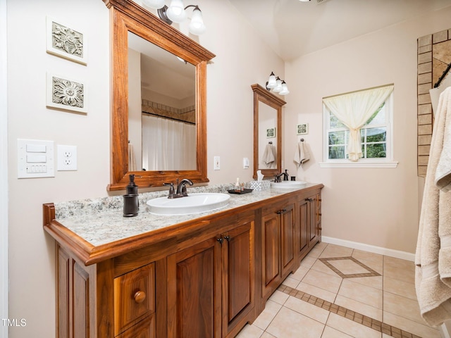 8917 Thompson Mill Rd, Wake Forest, NC 27587 - full bathroom with tile patterned floors, double vanity, and baseboards