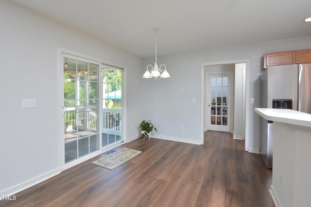 1056 Evening Shade Ave, Rolesville, NC 27571 - unfurnished dining area featuring dark wood finished floors, a chandelier, and baseboards