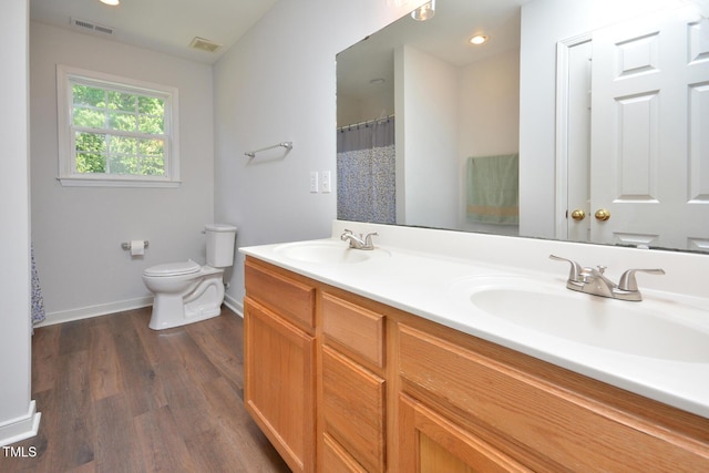 1056 Evening Shade Ave, Rolesville, NC 27571 - full bath featuring toilet, double vanity, baseboards, wood finished floors, and recessed lighting