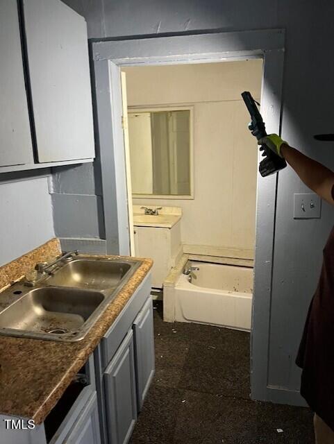 116 Dunstan Ave, Durham, NC 27707 - bathroom featuring a garden tub and vanity