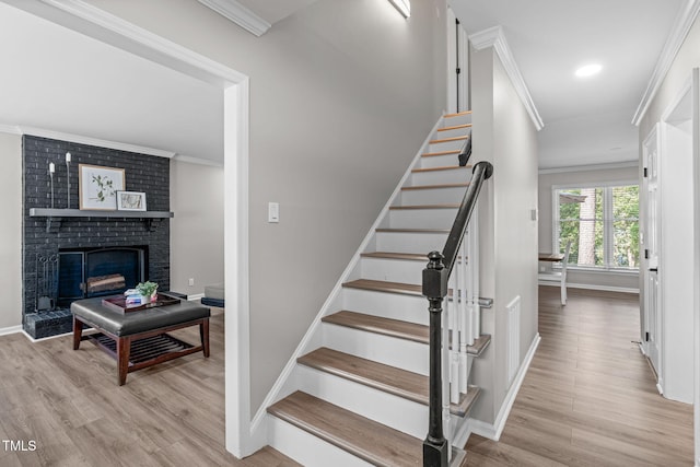3 Haggis Ct, Durham, NC 27705 - staircase featuring wood finished floors, crown molding, baseboards, a fireplace, and recessed lighting