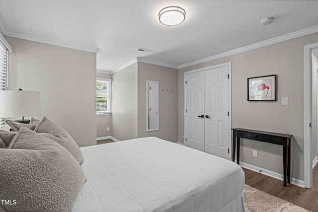 3 Haggis Ct, Durham, NC 27705 - bedroom with wood finished floors, ornamental molding, baseboards, and a closet