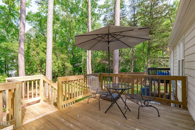 3 Haggis Ct, Durham, NC 27705 - wooden deck featuring outdoor dining space and view of wooded area