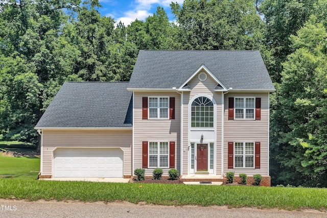 1325 Red Brick Rd, Garner, NC 27529 - colonial house featuring an attached garage and roof with shingles