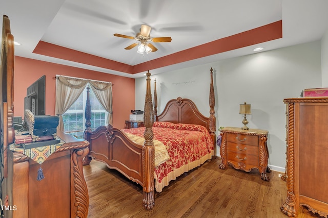 1325 Red Brick Rd, Garner, NC 27529 - bedroom featuring a tray ceiling, wood finished floors, a ceiling fan, baseboards, and recessed lighting