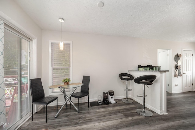 7368 Ryan St, Fayetteville, NC 28314 - dining area with dark wood finished floors, baseboards, and a textured ceiling