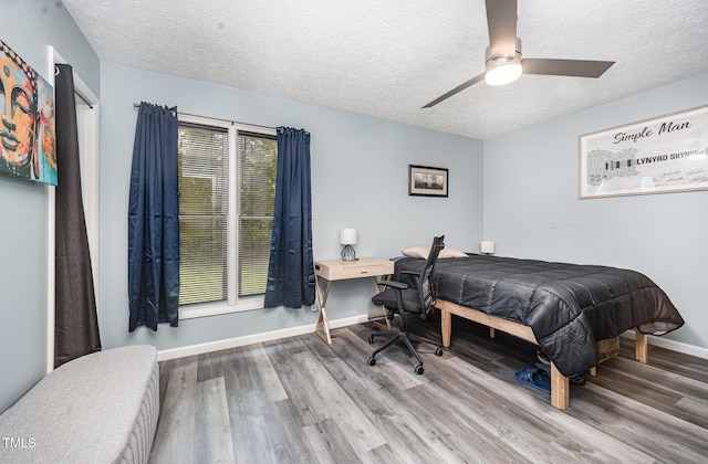 7368 Ryan St, Fayetteville, NC 28314 - bedroom with wood finished floors, a textured ceiling, baseboards, and a ceiling fan