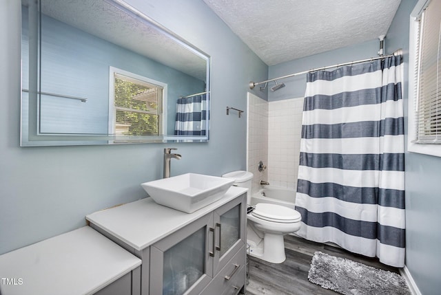 7368 Ryan St, Fayetteville, NC 28314 - full bathroom with a textured ceiling, vanity, toilet, wood finished floors, and shower / tub combo