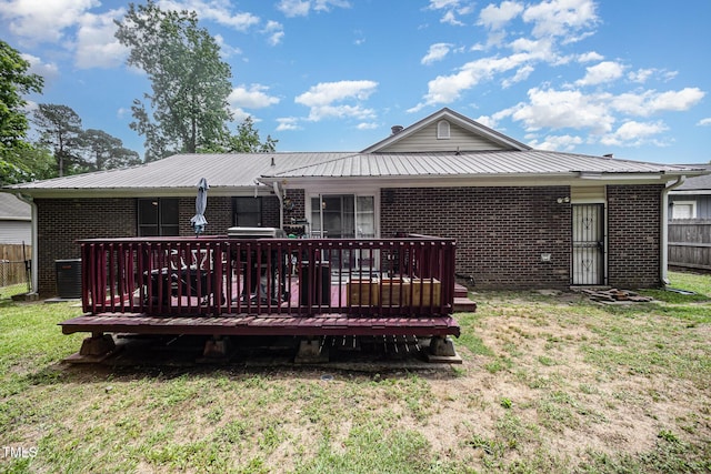 7368 Ryan St, Fayetteville, NC 28314 - back of property featuring brick siding, a wooden deck, and metal roof