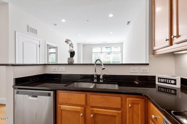 317 W Morgan St Unit 320, Raleigh, NC 27601 - kitchen with stainless steel dishwasher, a sink, brown cabinets, recessed lighting, and dark stone countertops