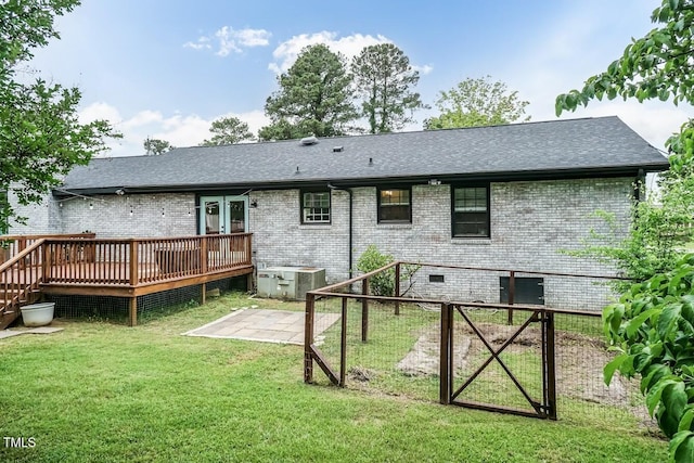 103 Midway Ln, Roanoke Rapids, NC 27870 - back of property with brick siding, a wooden deck, central AC unit, a lawn, and roof with shingles