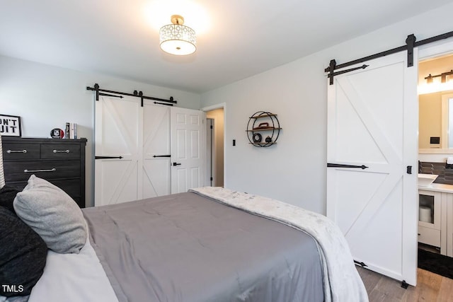 103 Midway Ln, Roanoke Rapids, NC 27870 - bedroom featuring a barn door and wood finished floors