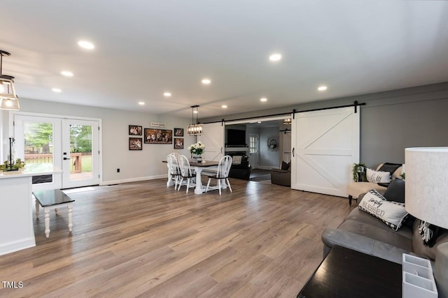 103 Midway Ln, Roanoke Rapids, NC 27870 - living room featuring a barn door, recessed lighting, wood finished floors, baseboards, and french doors