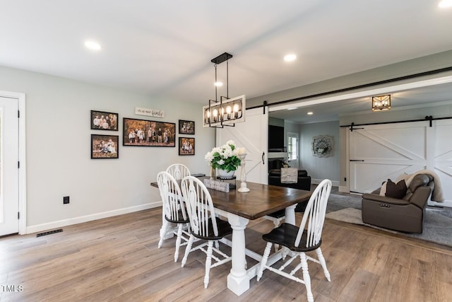 103 Midway Ln, Roanoke Rapids, NC 27870 - dining room with a barn door, light wood finished floors, baseboards, and recessed lighting