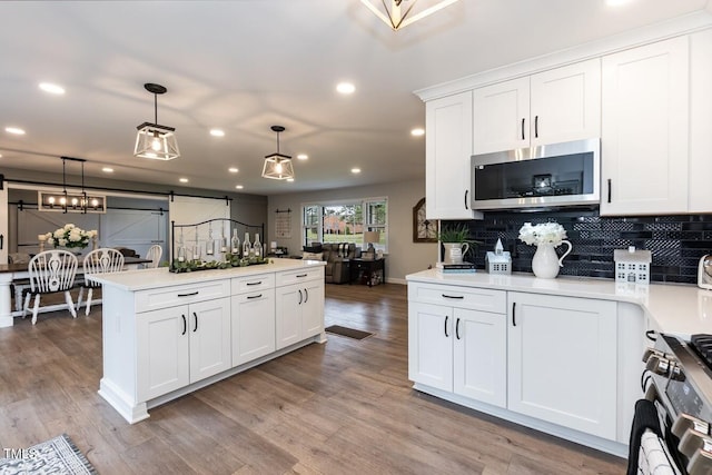 103 Midway Ln, Roanoke Rapids, NC 27870 - kitchen featuring appliances with stainless steel finishes, recessed lighting, light countertops, backsplash, and decorative light fixtures