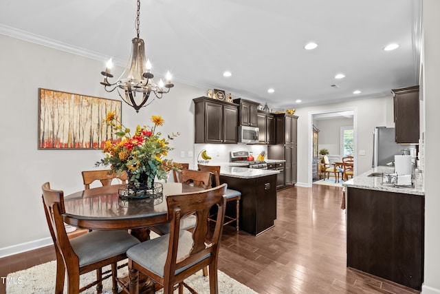 633 Copper Beech Ln, Wake Forest, NC 27587 - dining space featuring a chandelier, crown molding, recessed lighting, dark wood-type flooring, and baseboards