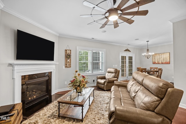 633 Copper Beech Ln, Wake Forest, NC 27587 - living room with a chandelier, crown molding, a fireplace with flush hearth, a ceiling fan, and wood finished floors