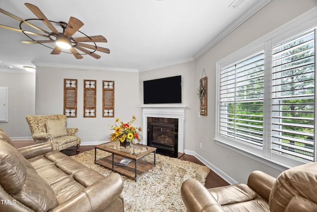 633 Copper Beech Ln, Wake Forest, NC 27587 - living area featuring a ceiling fan, crown molding, baseboards, and a glass covered fireplace