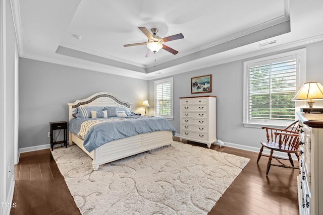 633 Copper Beech Ln, Wake Forest, NC 27587 - bedroom featuring a tray ceiling, dark wood finished floors, ornamental molding, baseboards, and a ceiling fan