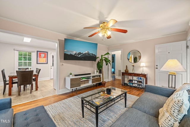 1905 Bivins St, Durham, NC 27707 - living room featuring light wood-style flooring, a ceiling fan, crown molding, and baseboards