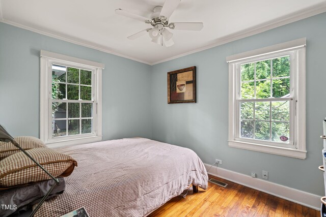 1905 Bivins St, Durham, NC 27707 - bedroom with crown molding, baseboards, wood finished floors, and ceiling fan