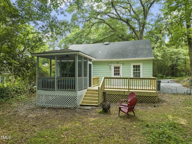 1905 Bivins St, Durham, NC 27707 - back of property with a sunroom, a deck, and a shingled roof