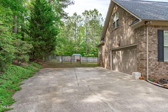 1016 Luminary Ln, Willow Springs, NC 27592 - view of home's exterior with a shingled roof, brick siding, concrete driveway, and an attached garage