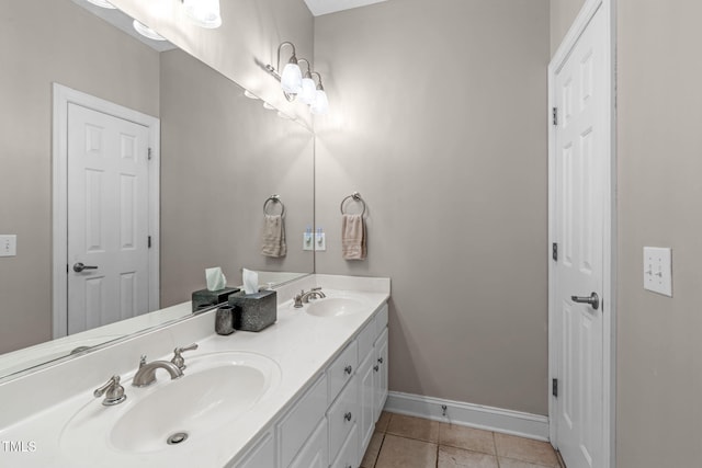 1016 Luminary Ln, Willow Springs, NC 27592 - bathroom featuring double vanity, baseboards, and tile patterned floors