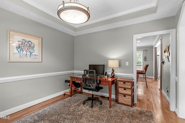 1016 Luminary Ln, Willow Springs, NC 27592 - home office featuring ornamental molding, wood finished floors, a textured ceiling, a raised ceiling, and baseboards