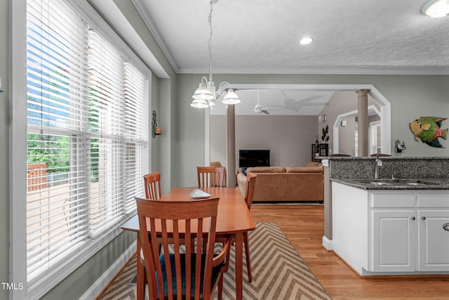 1016 Luminary Ln, Willow Springs, NC 27592 - dining space with light wood-type flooring, a chandelier, ornamental molding, recessed lighting, and decorative columns