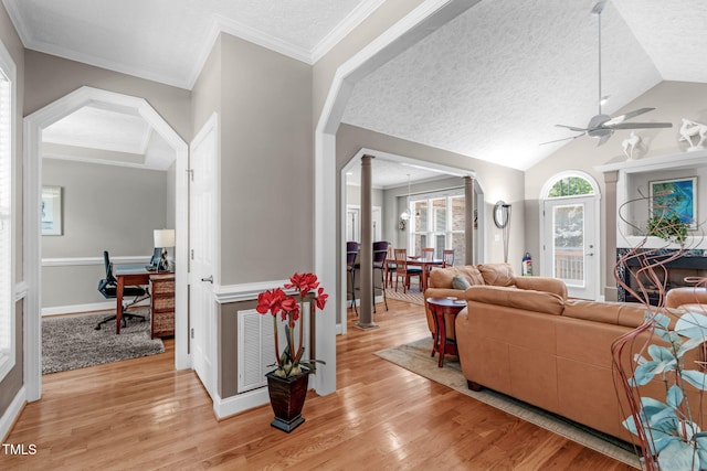 1016 Luminary Ln, Willow Springs, NC 27592 - living room featuring light wood finished floors, a ceiling fan, a textured ceiling, vaulted ceiling, and a desk