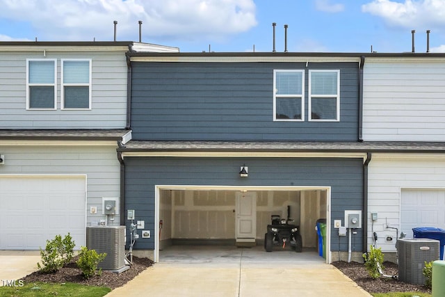 433 Parker Station Ave, Fuquay Varina, NC 27526 - rear view of house with central air condition unit, a garage, and concrete driveway