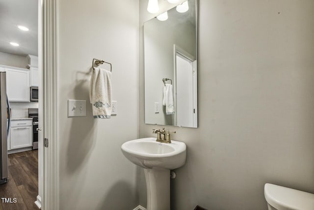 433 Parker Station Ave, Fuquay Varina, NC 27526 - half bathroom featuring toilet, wood finished floors, recessed lighting, and backsplash