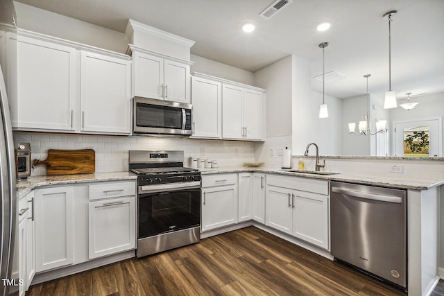 433 Parker Station Ave, Fuquay Varina, NC 27526 - kitchen with appliances with stainless steel finishes, a sink, a peninsula, dark wood-style floors, and recessed lighting