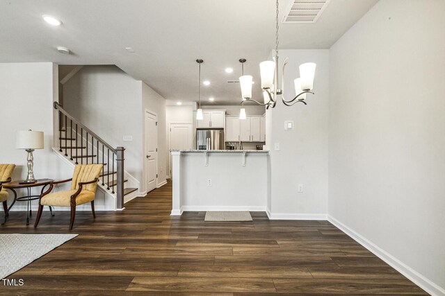 433 Parker Station Ave, Fuquay Varina, NC 27526 - kitchen with stainless steel refrigerator with ice dispenser, a chandelier, dark wood-style floors, white cabinets, and baseboards