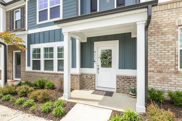 433 Parker Station Ave, Fuquay Varina, NC 27526 - entrance to property featuring board and batten siding, brick siding, and covered porch