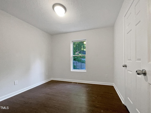 216 E Hinton St, Clayton, NC 27520 - spare room with dark wood finished floors, baseboards, and a textured ceiling