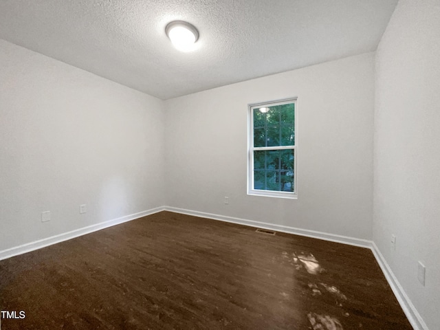 216 E Hinton St, Clayton, NC 27520 - unfurnished room with a textured ceiling, baseboards, and dark wood-style flooring