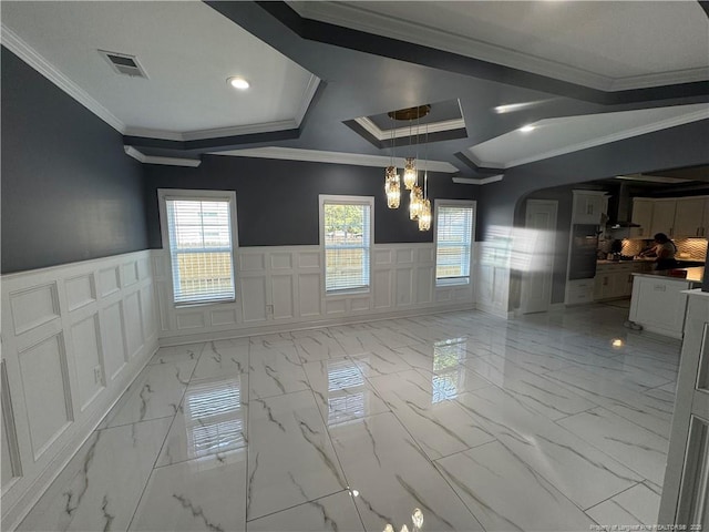 504 E Edinborough Ave, Raeford, NC 28376 - empty room featuring a decorative wall, light marble finish flooring, a chandelier, wainscoting, and crown molding