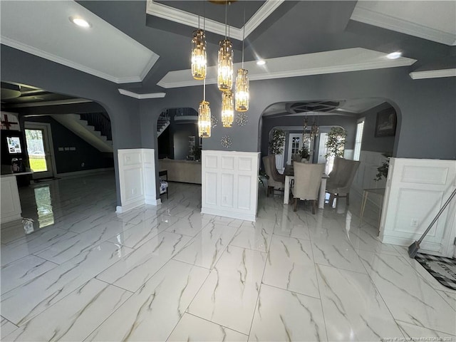 504 E Edinborough Ave, Raeford, NC 28376 - dining area with arched walkways, ornamental molding, a chandelier, a wainscoted wall, and stairway
