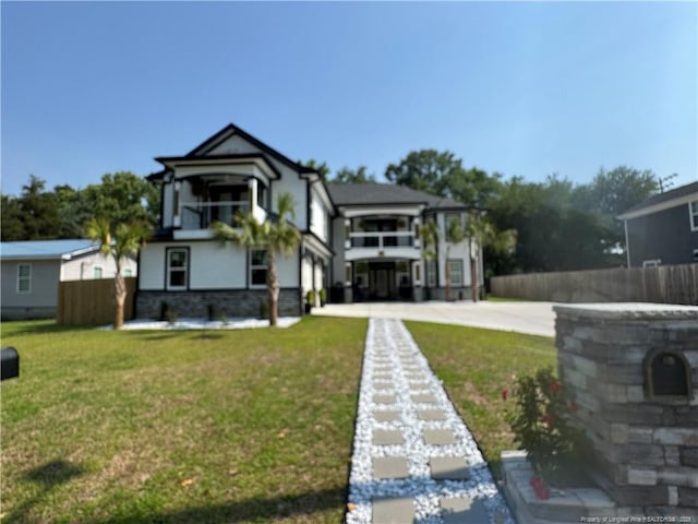 504 E Edinborough Ave, Raeford, NC 28376 - back of property featuring an attached garage, stucco siding, and concrete driveway