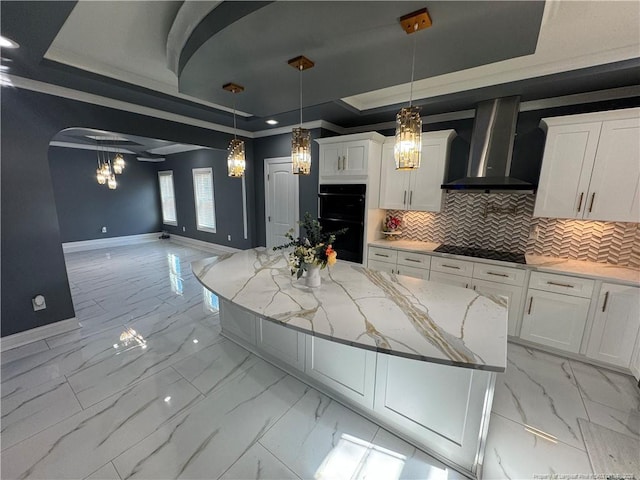 504 E Edinborough Ave, Raeford, NC 28376 - kitchen featuring wall chimney exhaust hood, a tray ceiling, light marble finish flooring, black appliances, and baseboards