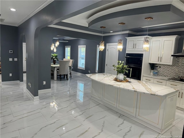 504 E Edinborough Ave, Raeford, NC 28376 - kitchen with baseboards, black appliances, arched walkways, a center island, and white cabinets